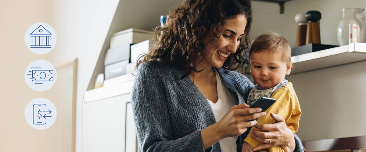 Young woman her baby looking at her cell phone